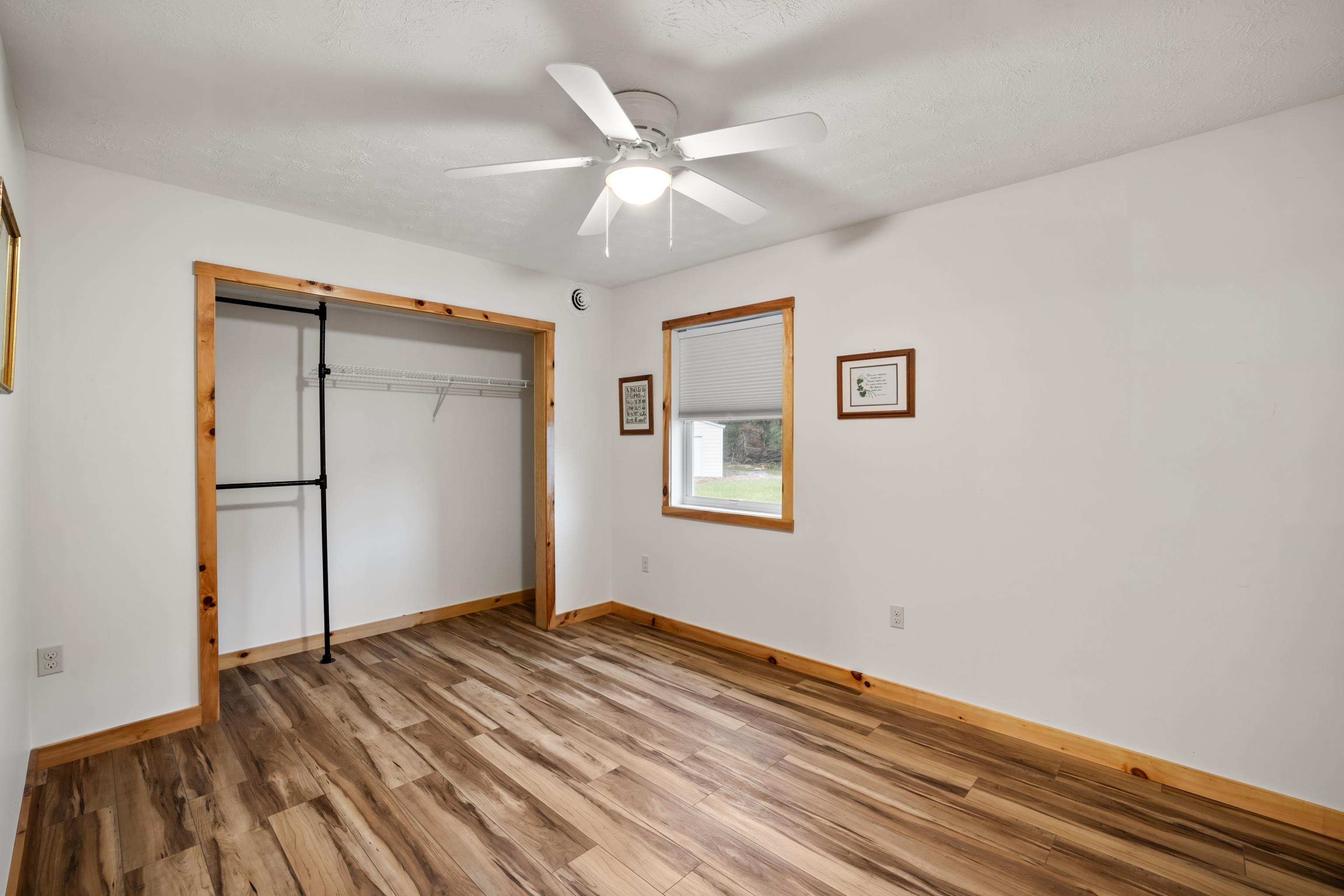 232 Old Back Road Raphine, VA 24472 - Photo 23 of 62 a view of a livingroom with wooden floor and a ceiling fan