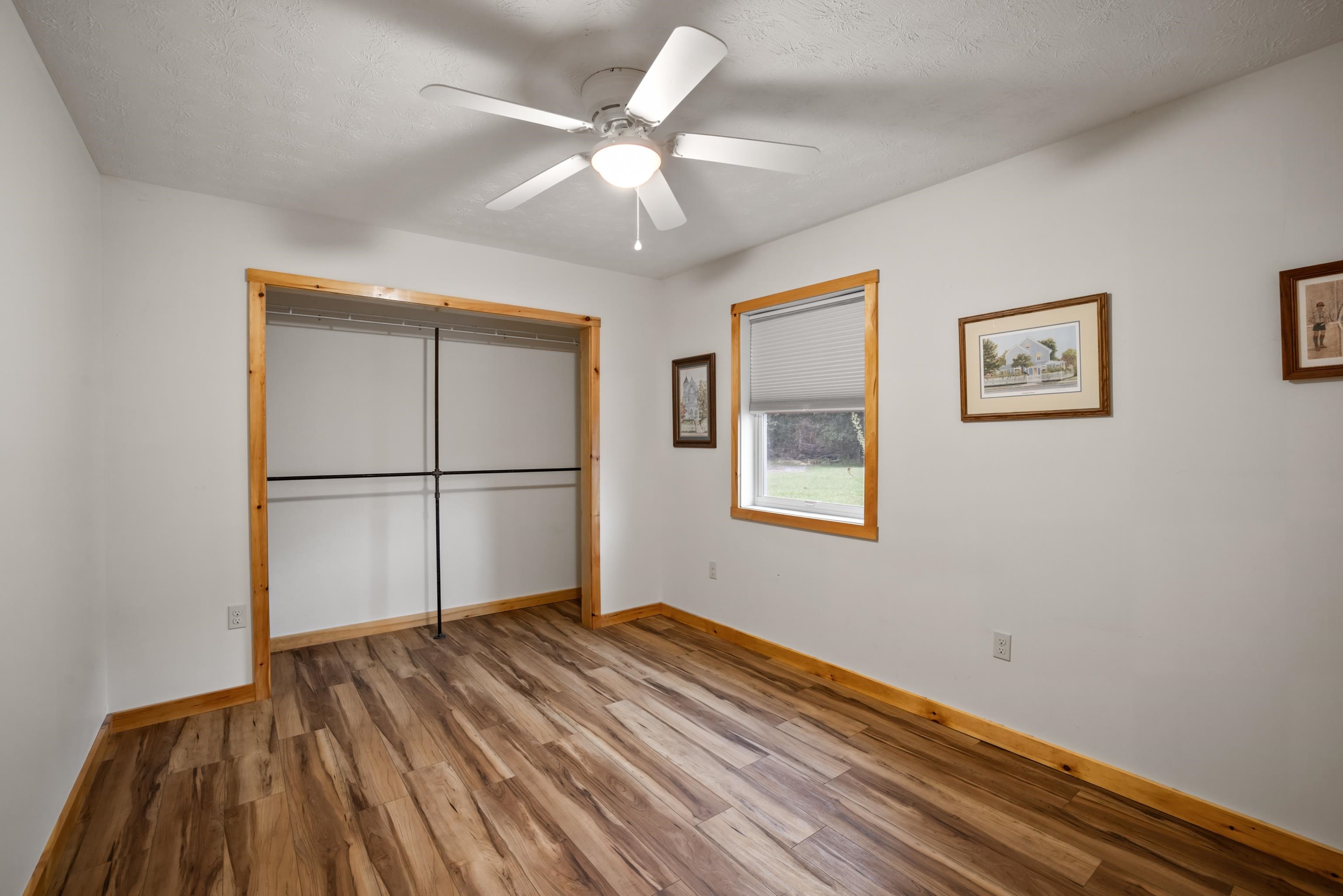 232 Old Back Road Raphine, VA 24472 - Photo 34 of 62 a view of a room with wooden floor and a ceiling fan