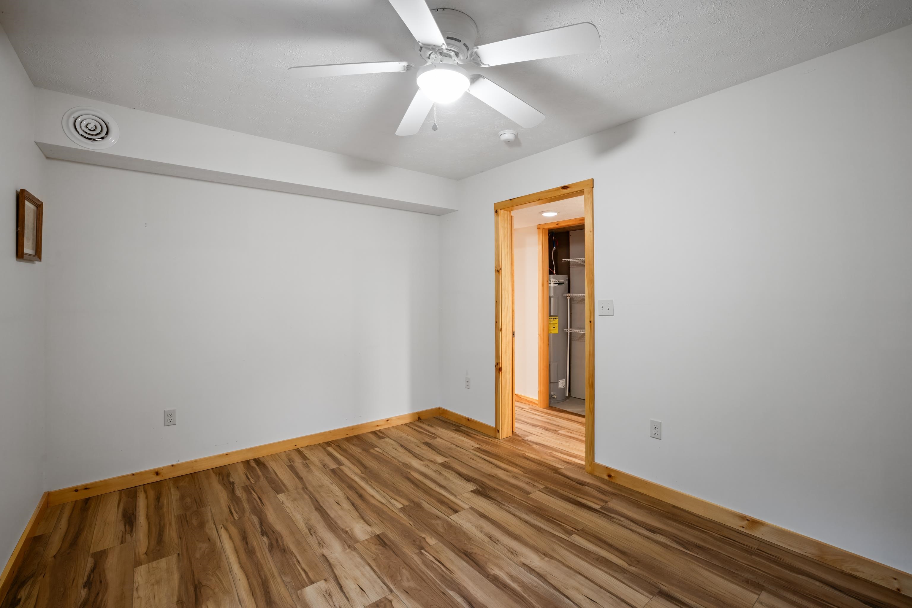 232 Old Back Road Raphine, VA 24472 - Photo 36 of 62 a view of a room with wooden floor and a ceiling fan
