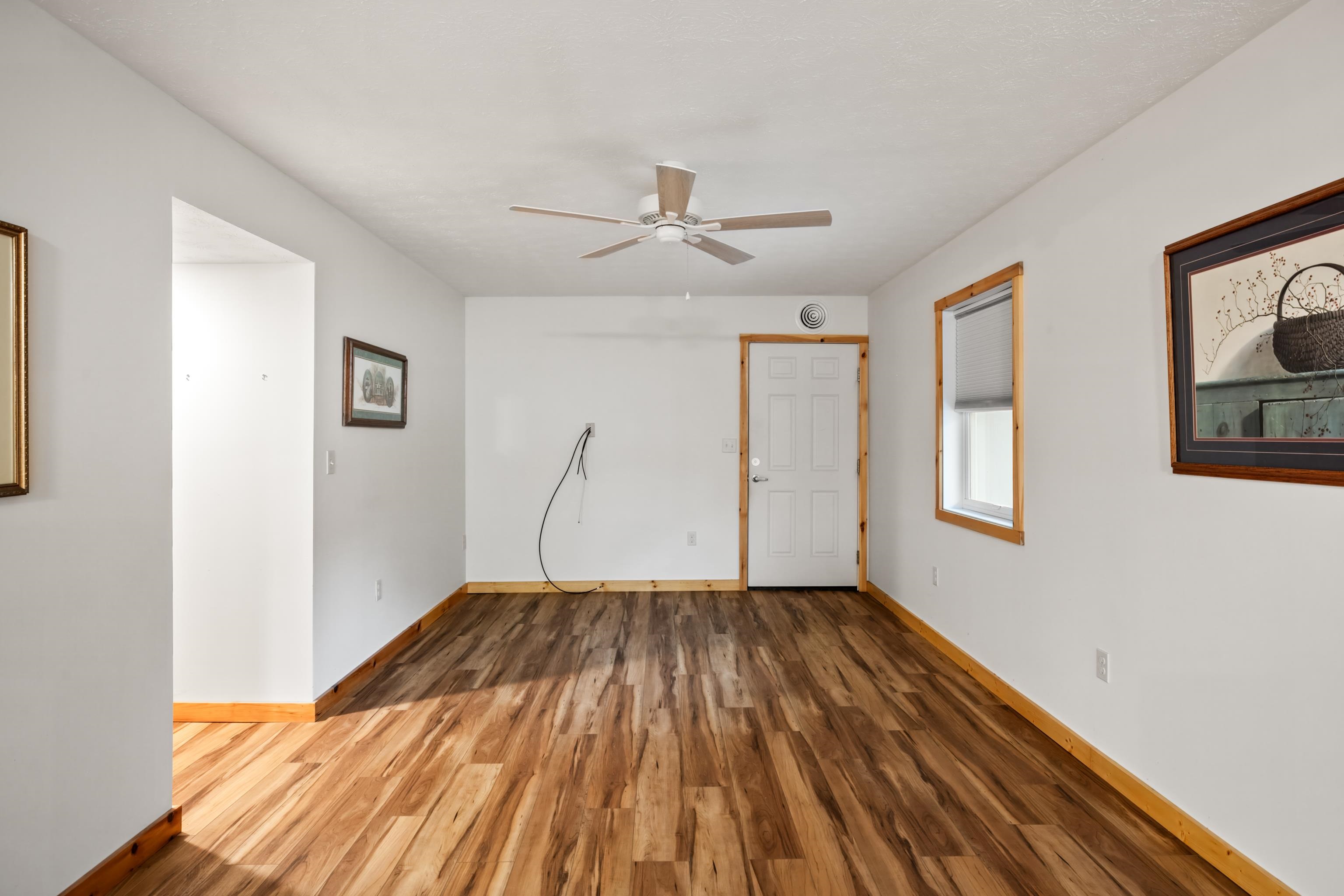 232 Old Back Road Raphine, VA 24472 - Photo 5 of 62 a view of a room with wooden floor ceiling fan and window
