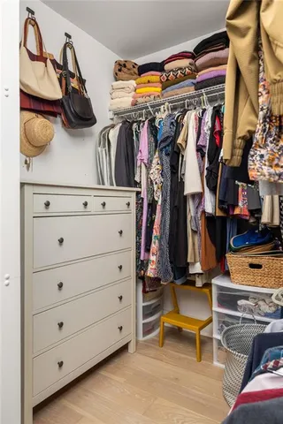 a large bed sitting in a bedroom next to a window