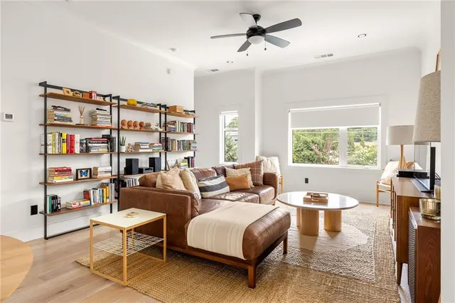 a living room with furniture a rug and a large window