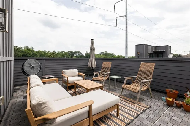 a view of deck with table and chairs and wooden floor