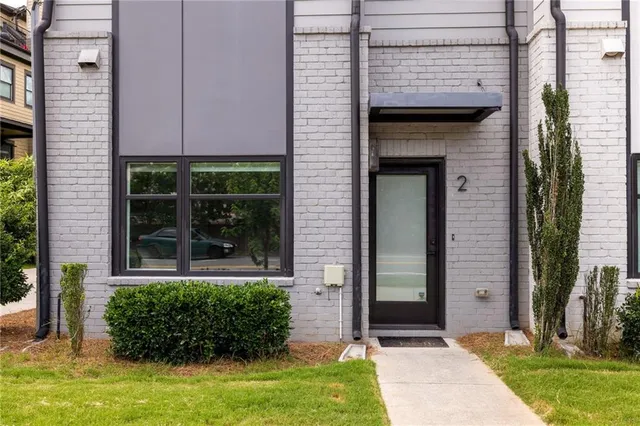 a view of front door and potted plants