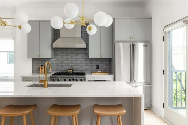 a kitchen with a dining table chairs cabinets and a window