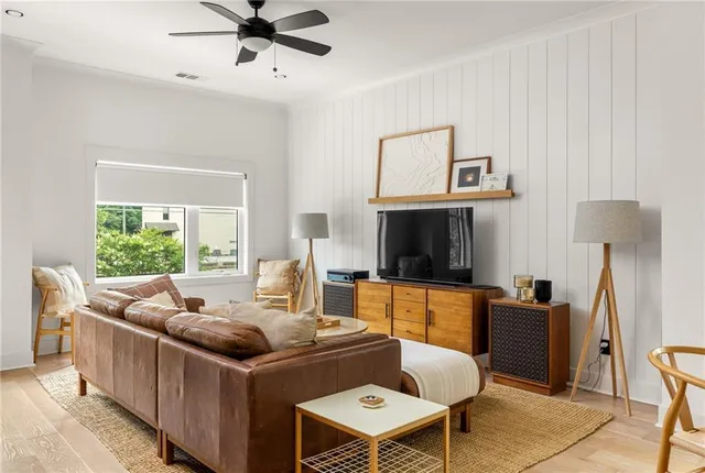 a living room with furniture and a book shelf