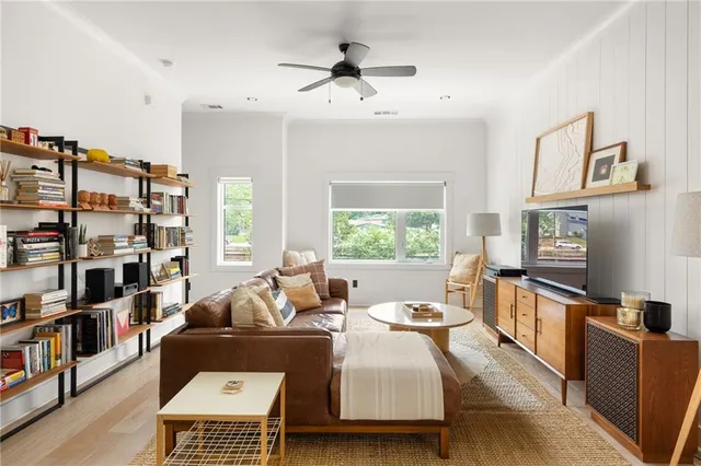 a living room with furniture a rug and a chandelier