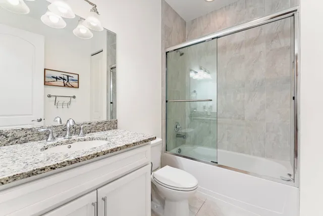 a bedroom with two beds and a chandelier