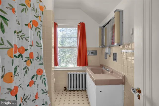 a bathroom with a sink a bath tub and a shower curtain