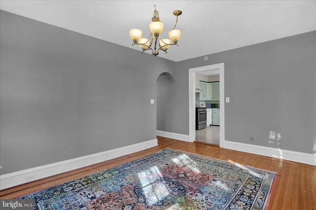 a view of a chandelier fan and wooden floor
