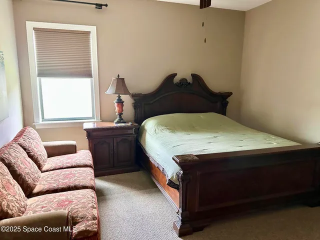 a bedroom with a bed and a couch