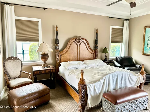 a bedroom with a bed chair and window