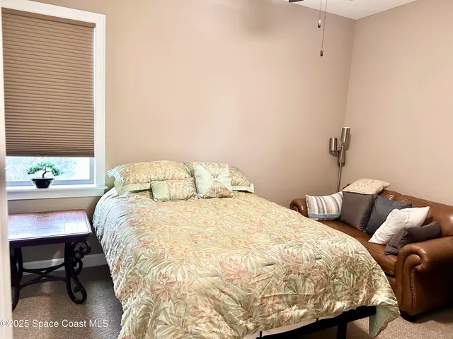 a bedroom with a bed and a table in it