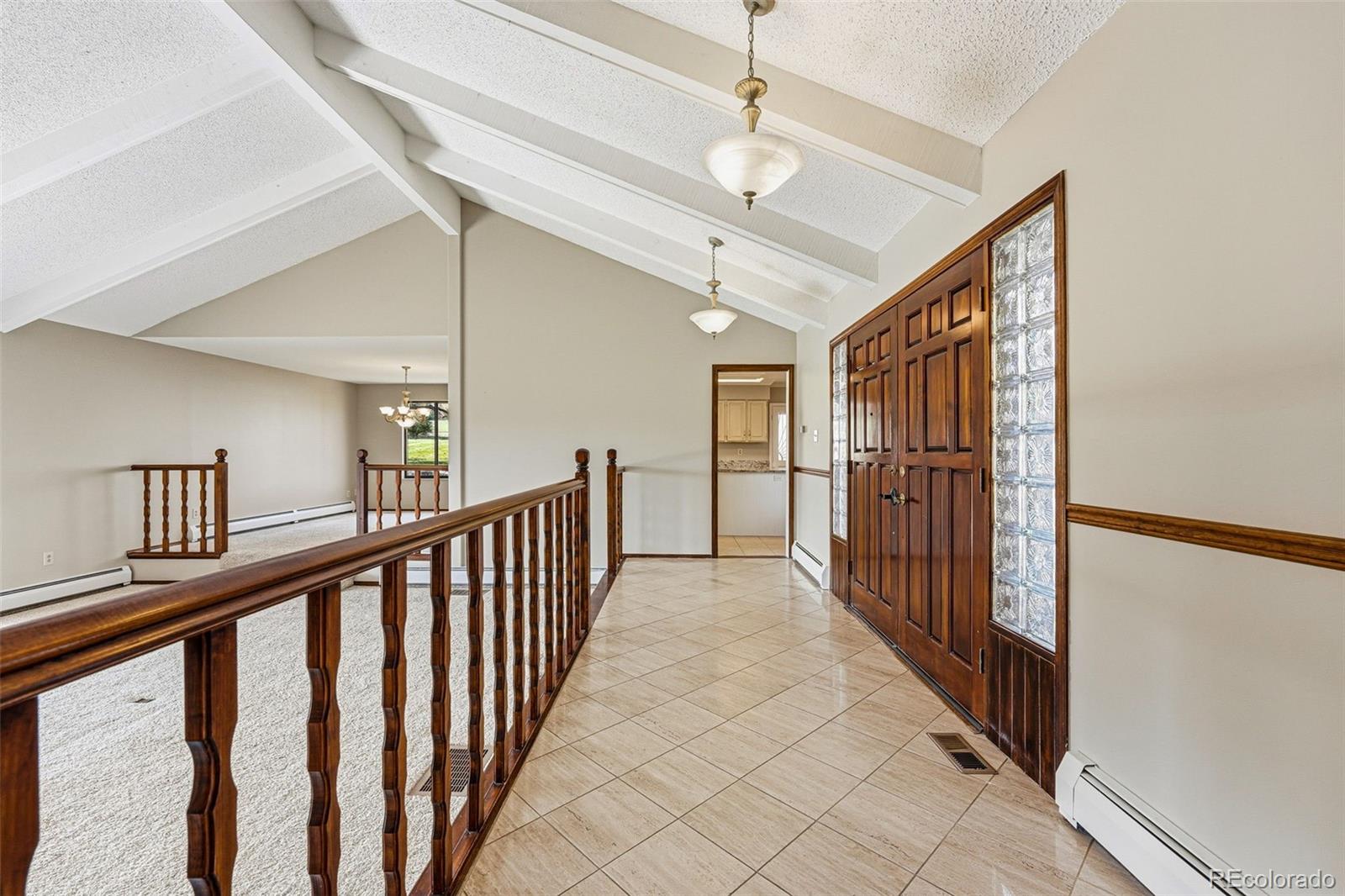 16066 Ridge Tee Drive Morrison, CO 80465 - Photo 14 of 41 a view of a hallway with wooden floor and entryway