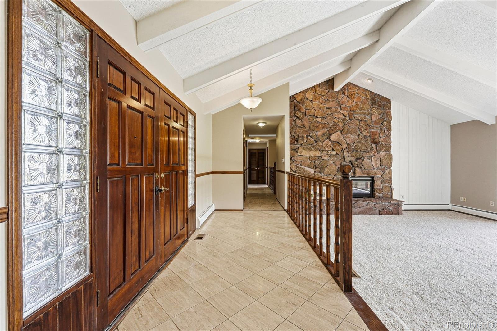 16066 Ridge Tee Drive Morrison, CO 80465 - Photo 15 of 41 a view of a hallway with wooden floor and staircase
