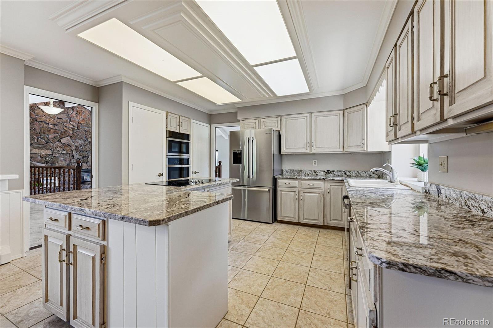 16066 Ridge Tee Drive Morrison, CO 80465 - Photo 2 of 41 a kitchen with granite countertop a sink stainless steel appliances and cabinets