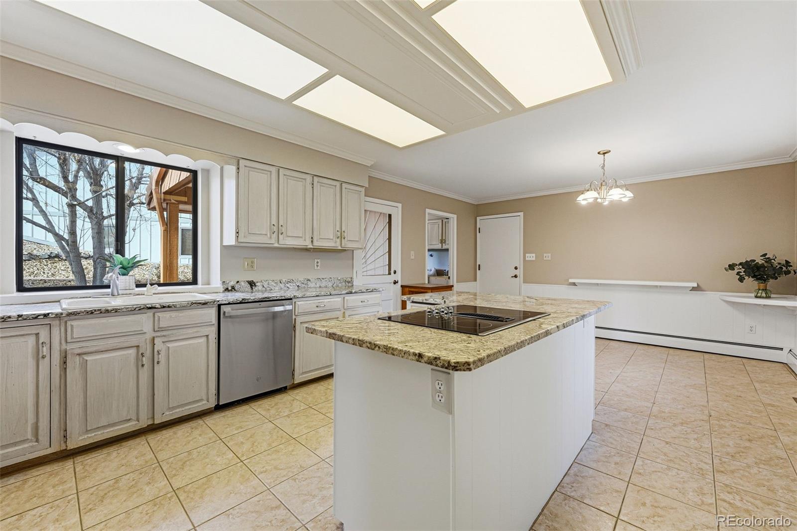 16066 Ridge Tee Drive Morrison, CO 80465 - Photo 24 of 41 a kitchen with granite countertop a sink stainless steel appliances and cabinets