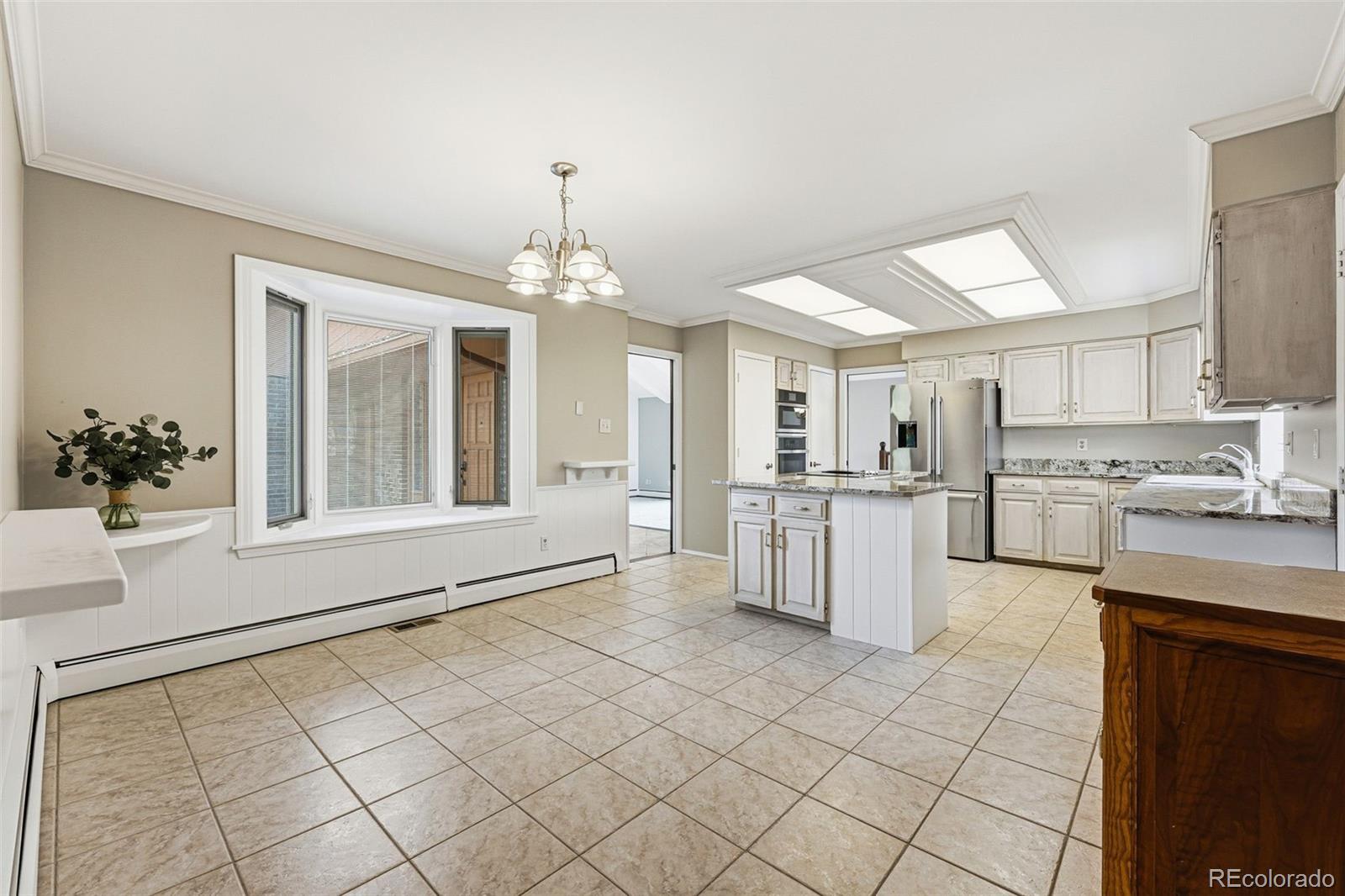 16066 Ridge Tee Drive Morrison, CO 80465 - Photo 26 of 41 a large white kitchen with cabinets