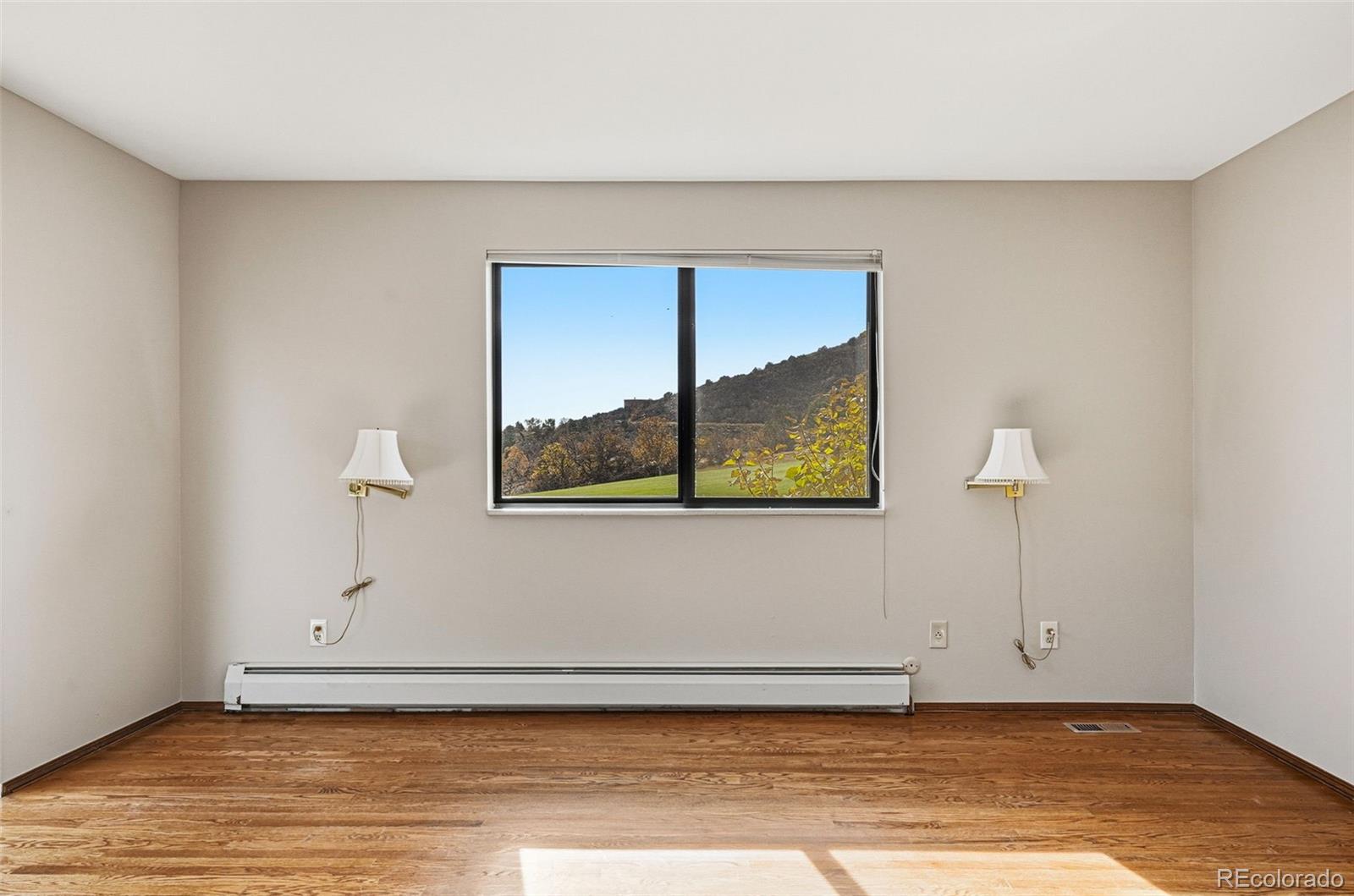 16066 Ridge Tee Drive Morrison, CO 80465 - Photo 27 of 41 a view of a livingroom with wooden floor and a window