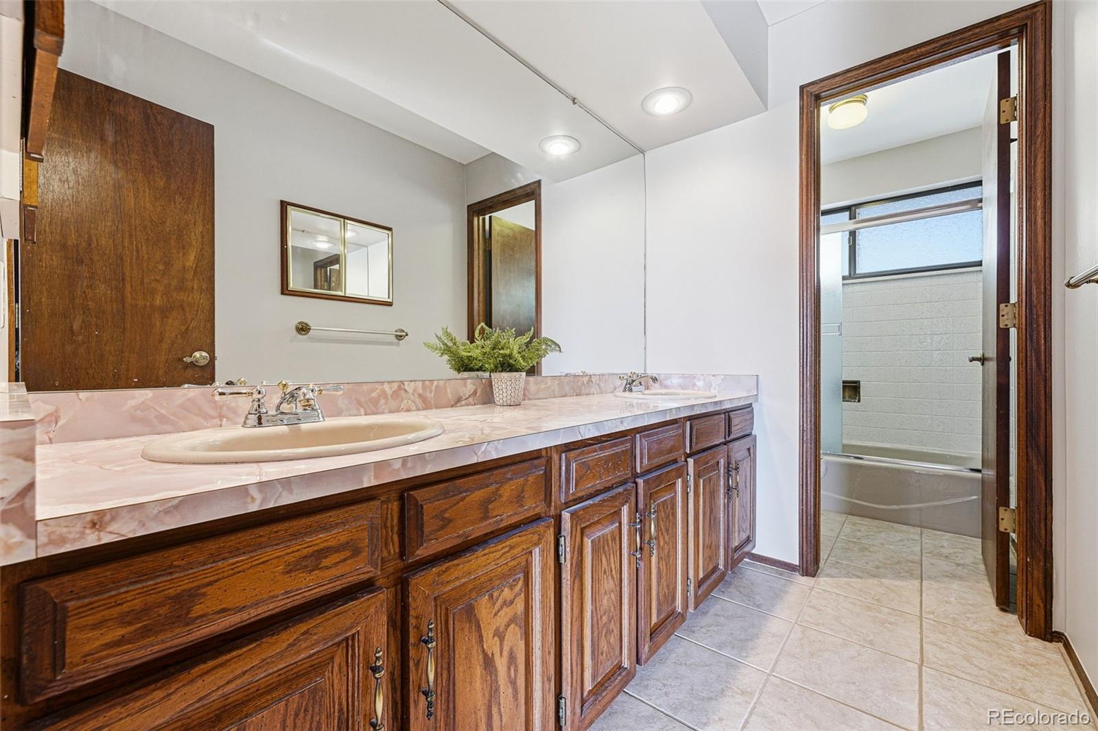 16066 Ridge Tee Drive Morrison, CO 80465 - Photo 32 of 41 a bathroom with double sink and a mirror