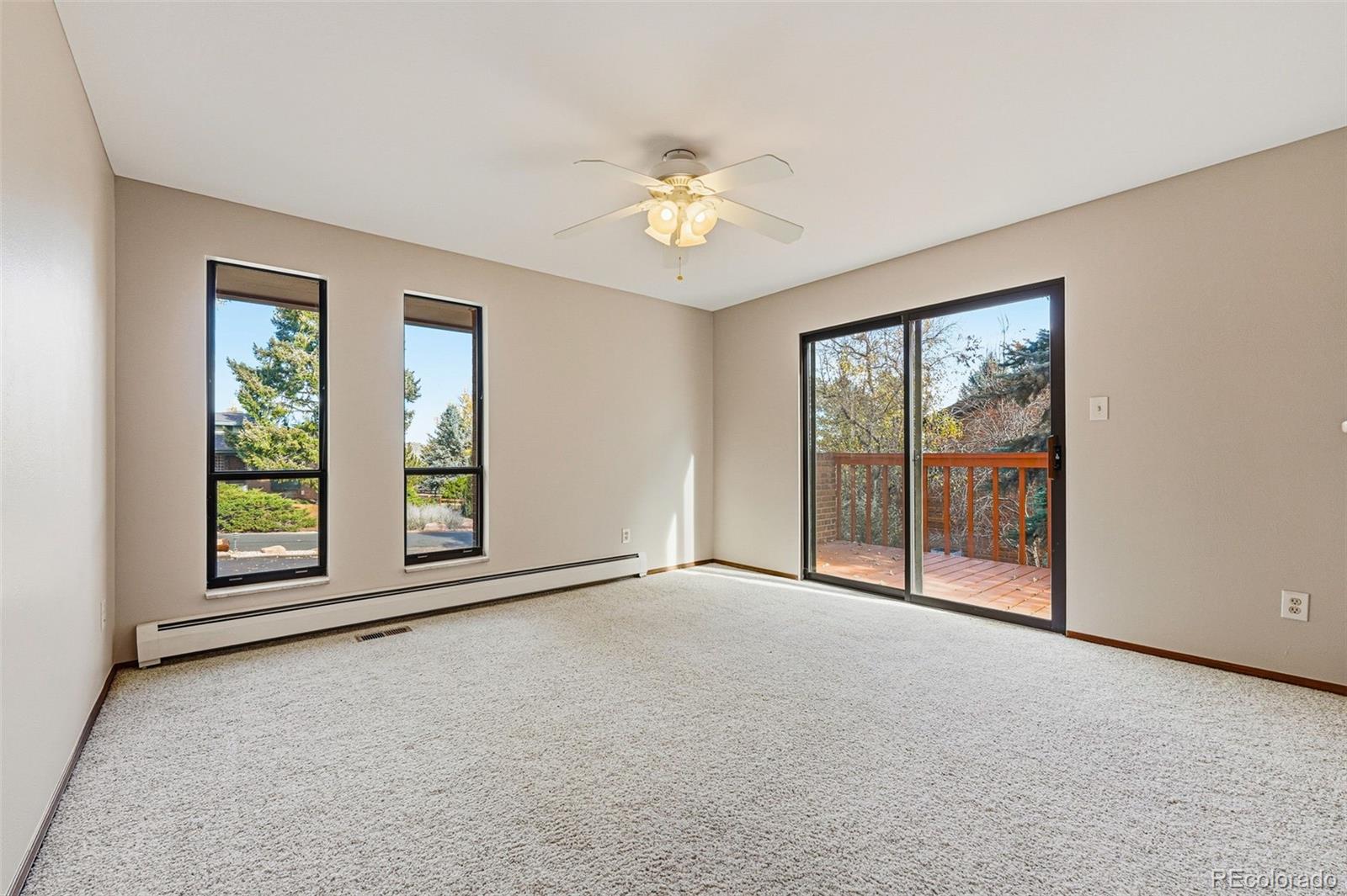 16066 Ridge Tee Drive Morrison, CO 80465 - Photo 33 of 41 an empty room with windows and chandelier fan