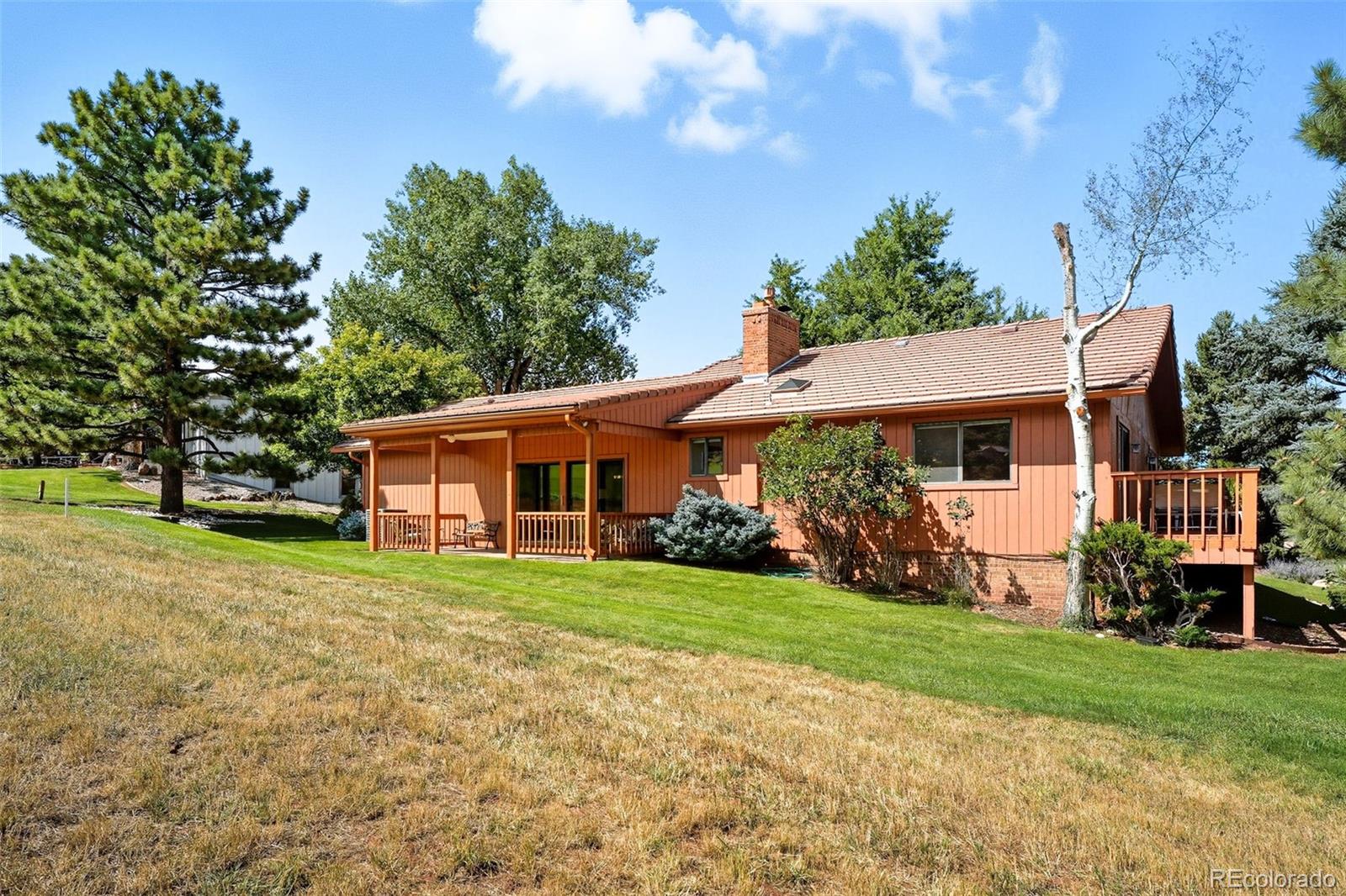 16066 Ridge Tee Drive Morrison, CO 80465 - Photo 36 of 41 a front view of a house with a yard