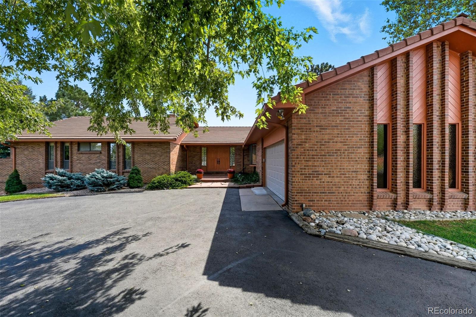16066 Ridge Tee Drive Morrison, CO 80465 - Photo 5 of 41 a front view of house with yard and trees around