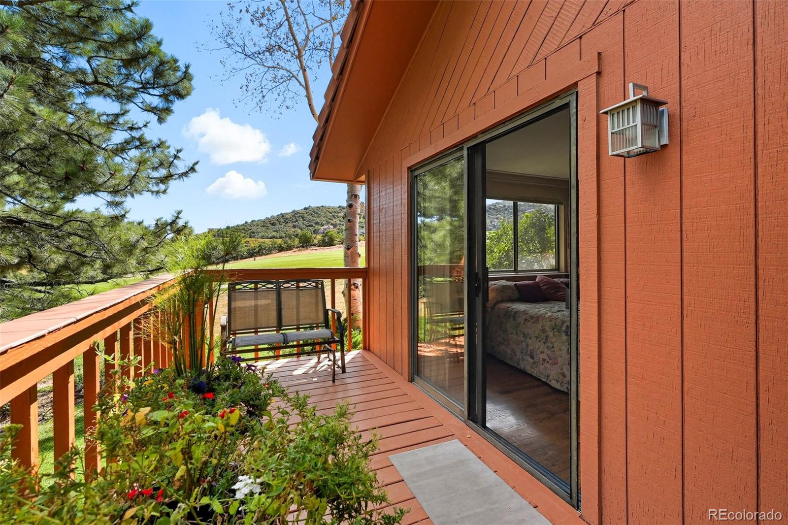 16066 Ridge Tee Drive Morrison, CO 80465 - Photo 10 of 41 a balcony with chairs and wooden fence