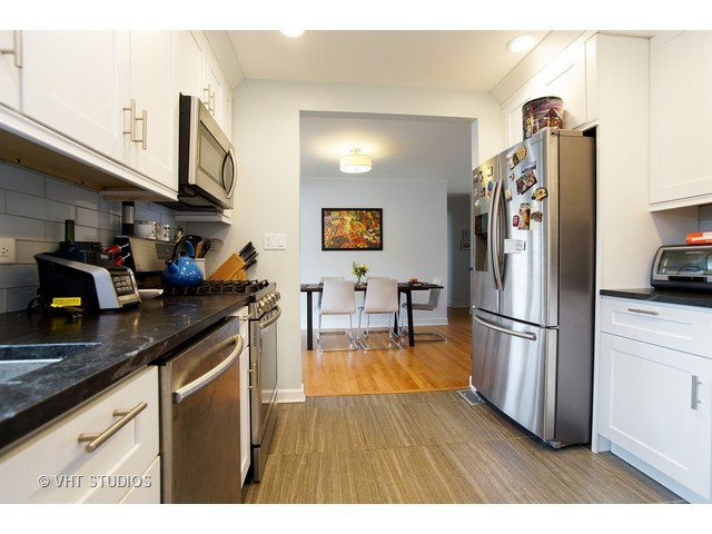 1813 Marguerite Street Park Ridge, IL 60068 - Photo 6 of 15 a kitchen with stainless steel appliances granite countertop a refrigerator a sink and white cabinets