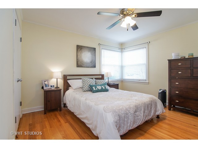 1813 Marguerite Street Park Ridge, IL 60068 - Photo 9 of 15 a bedroom with a bed and a chandelier