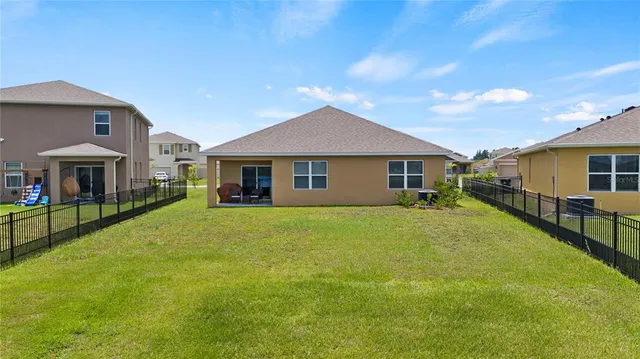a view of a house with a yard and sitting area