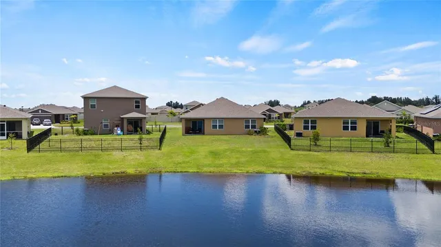 a view of a house with pool and a big yard