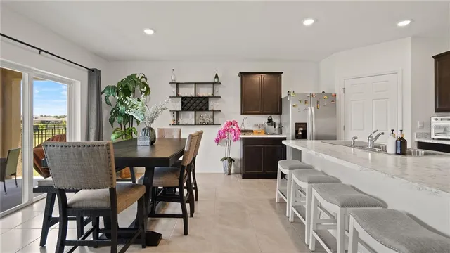 a dining room with furniture and a floor to ceiling window