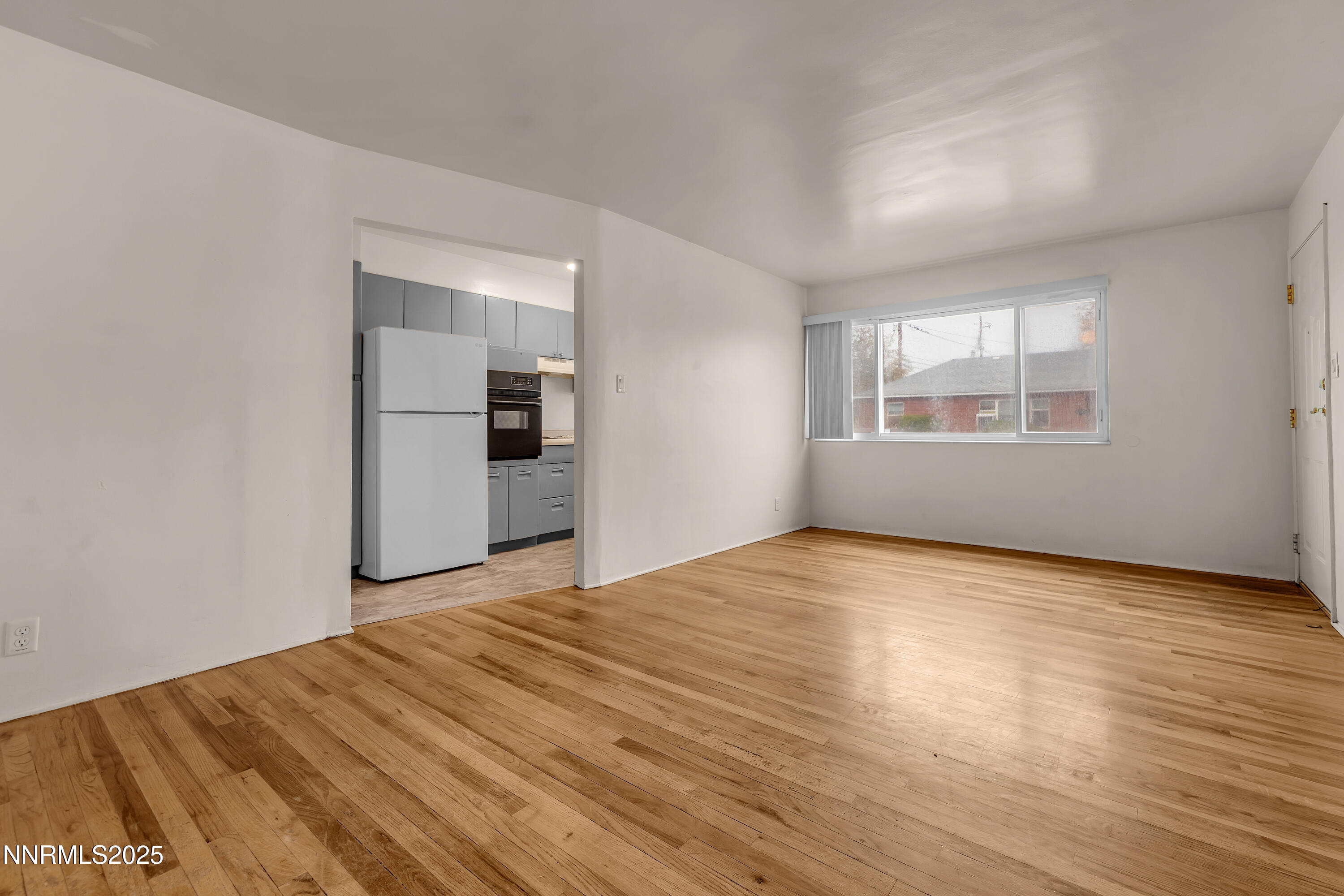 234 18th Street Sparks, NV 89431 - Photo 12 of 51 an empty room with wooden floor cabinet and windows