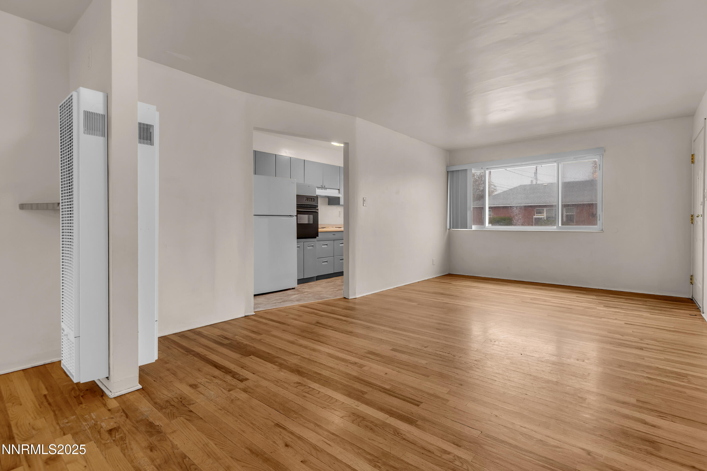 234 18th Street Sparks, NV 89431 - Photo 13 of 51 a view of empty room with wooden floor and fan