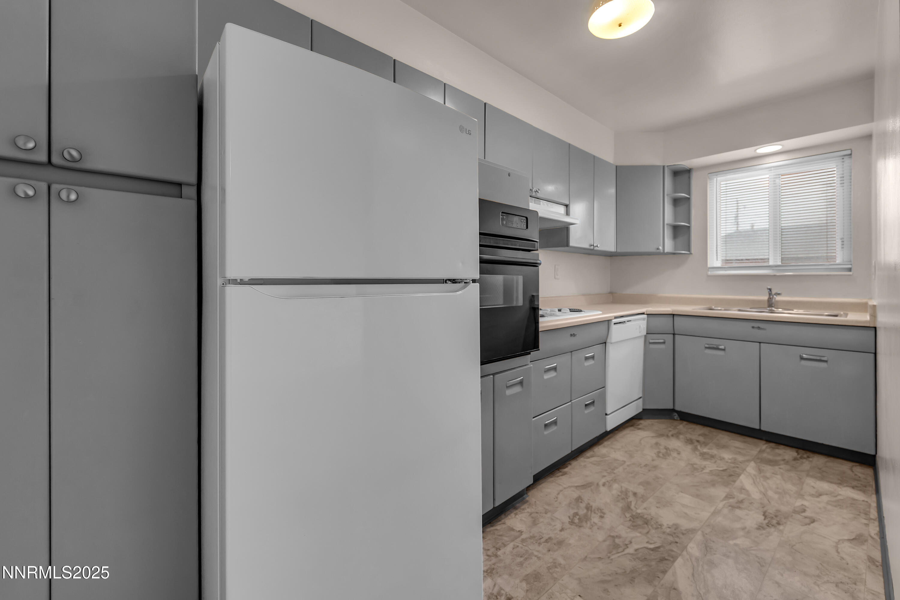 234 18th Street Sparks, NV 89431 - Photo 16 of 51 a kitchen with white cabinets and white appliances
