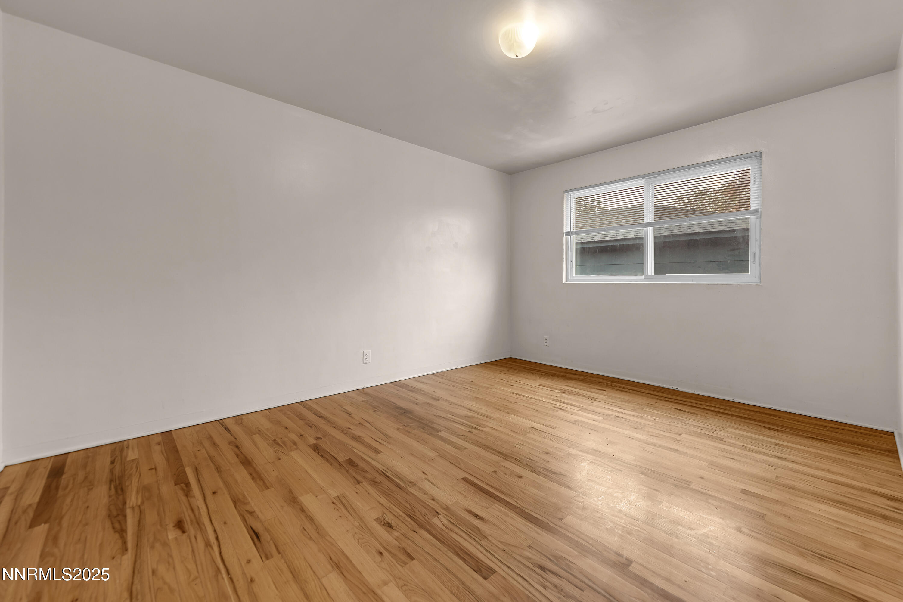 234 18th Street Sparks, NV 89431 - Photo 21 of 51 a view of an empty room with wooden floor and a window