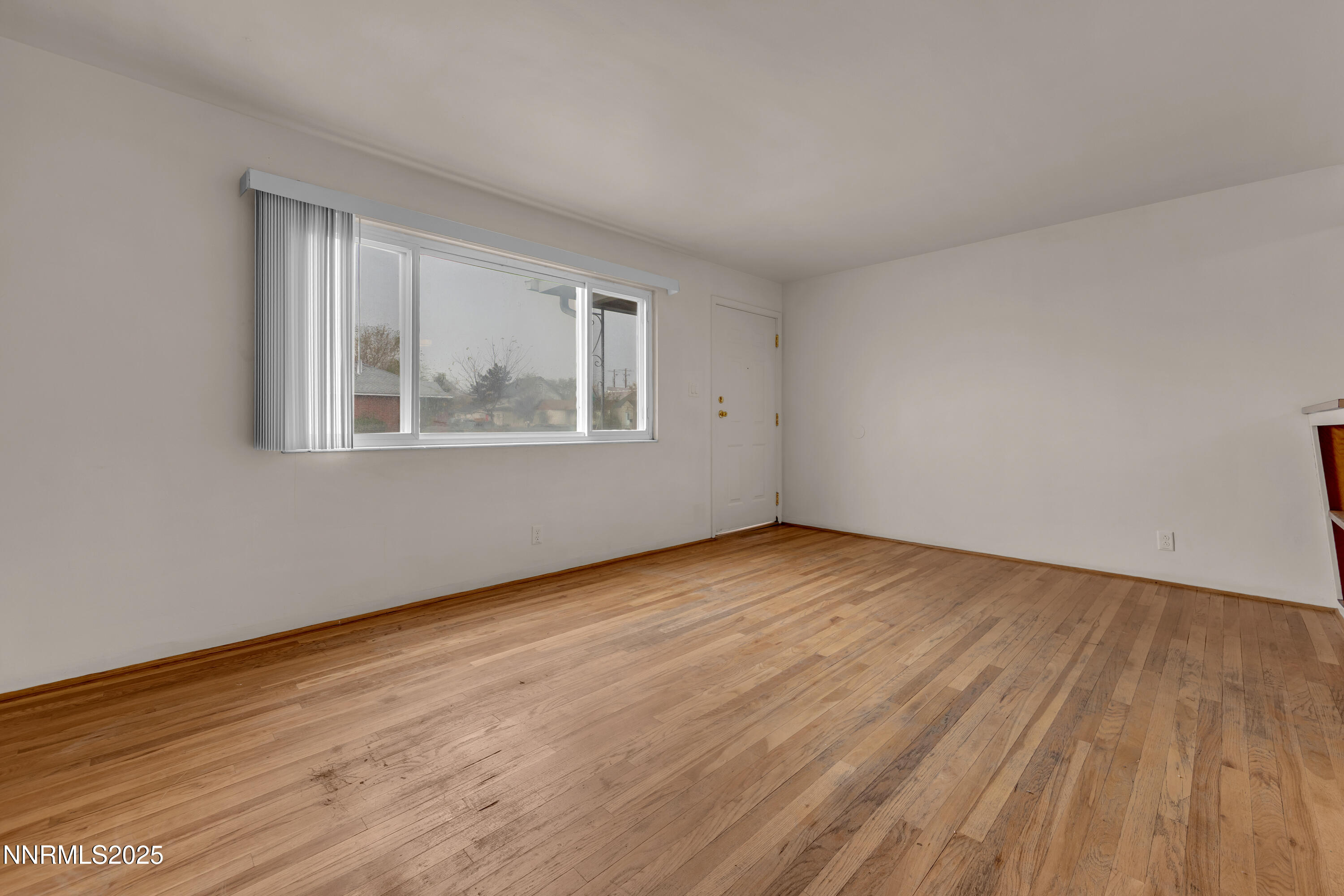 234 18th Street Sparks, NV 89431 - Photo 25 of 51 a view of an empty room with wooden floor and a window