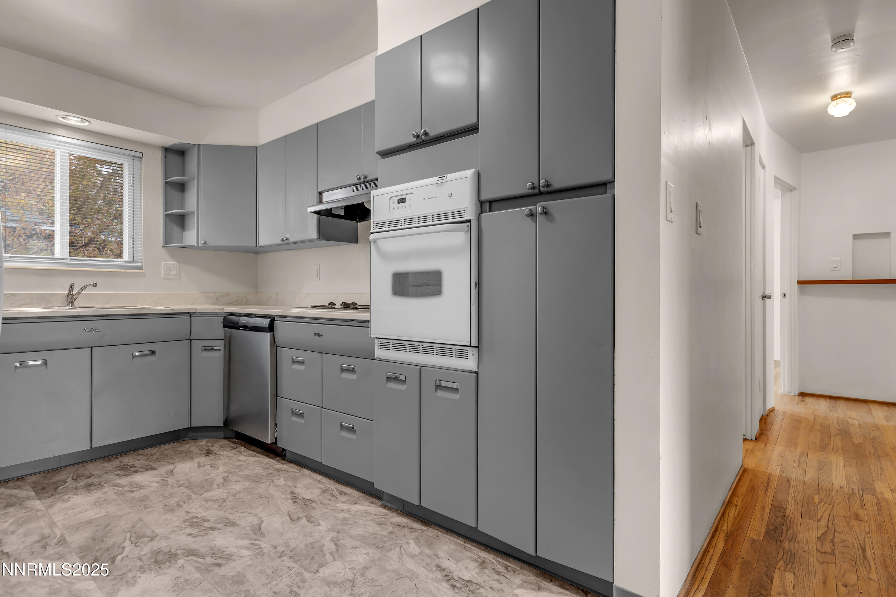 234 18th Street Sparks, NV 89431 - Photo 27 of 51 a kitchen with cabinets and white stainless steel appliances
