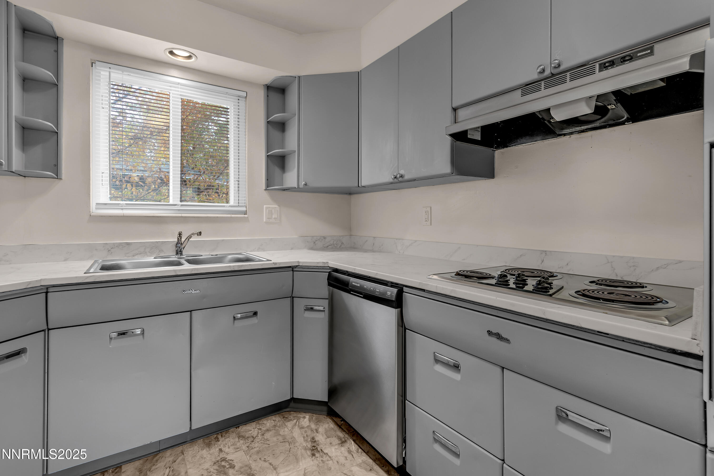 234 18th Street Sparks, NV 89431 - Photo 28 of 51 a kitchen with granite countertop a sink stove and cabinets
