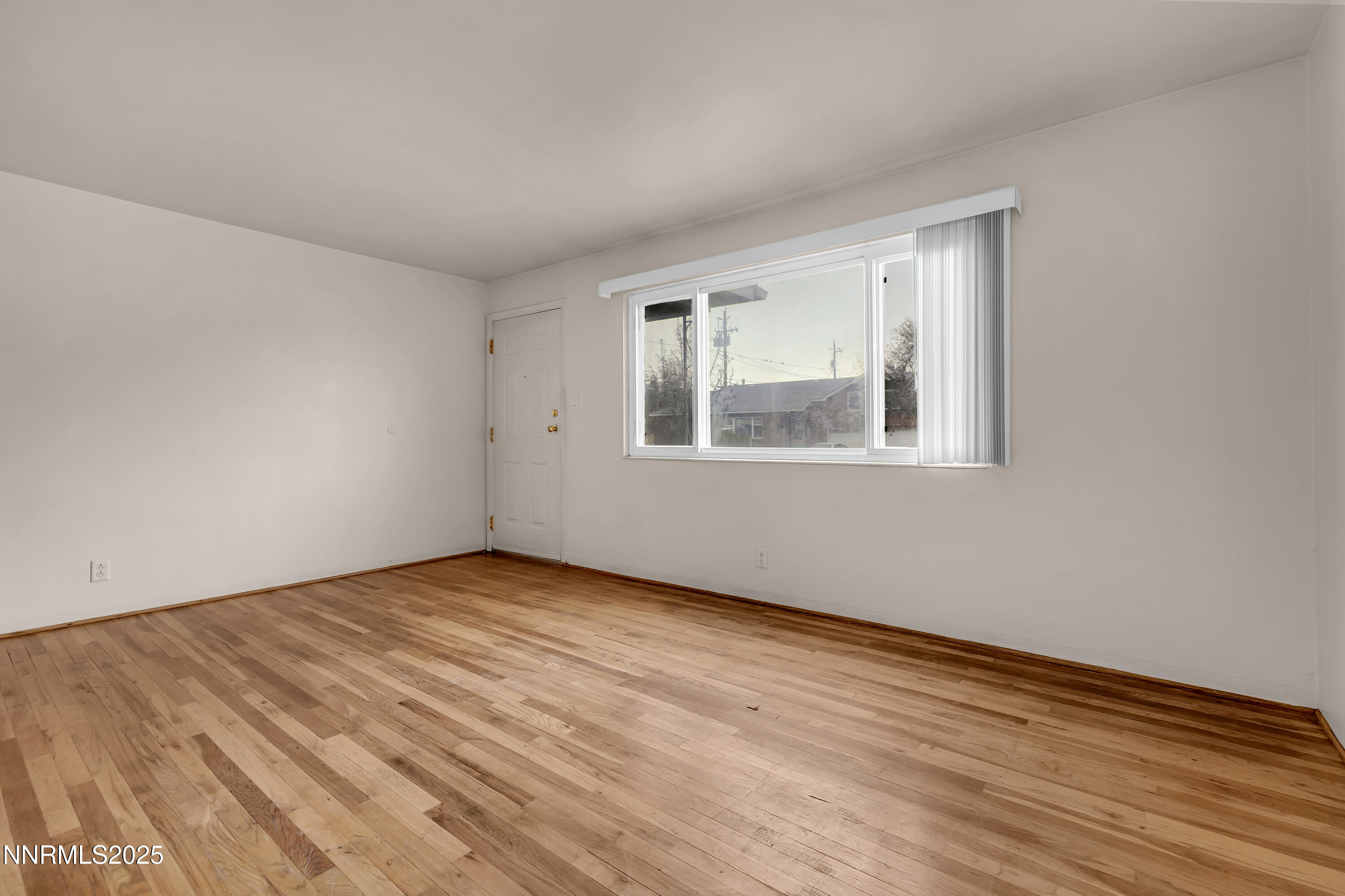 234 18th Street Sparks, NV 89431 - Photo 39 of 51 a view of an empty room with wooden floor and a window