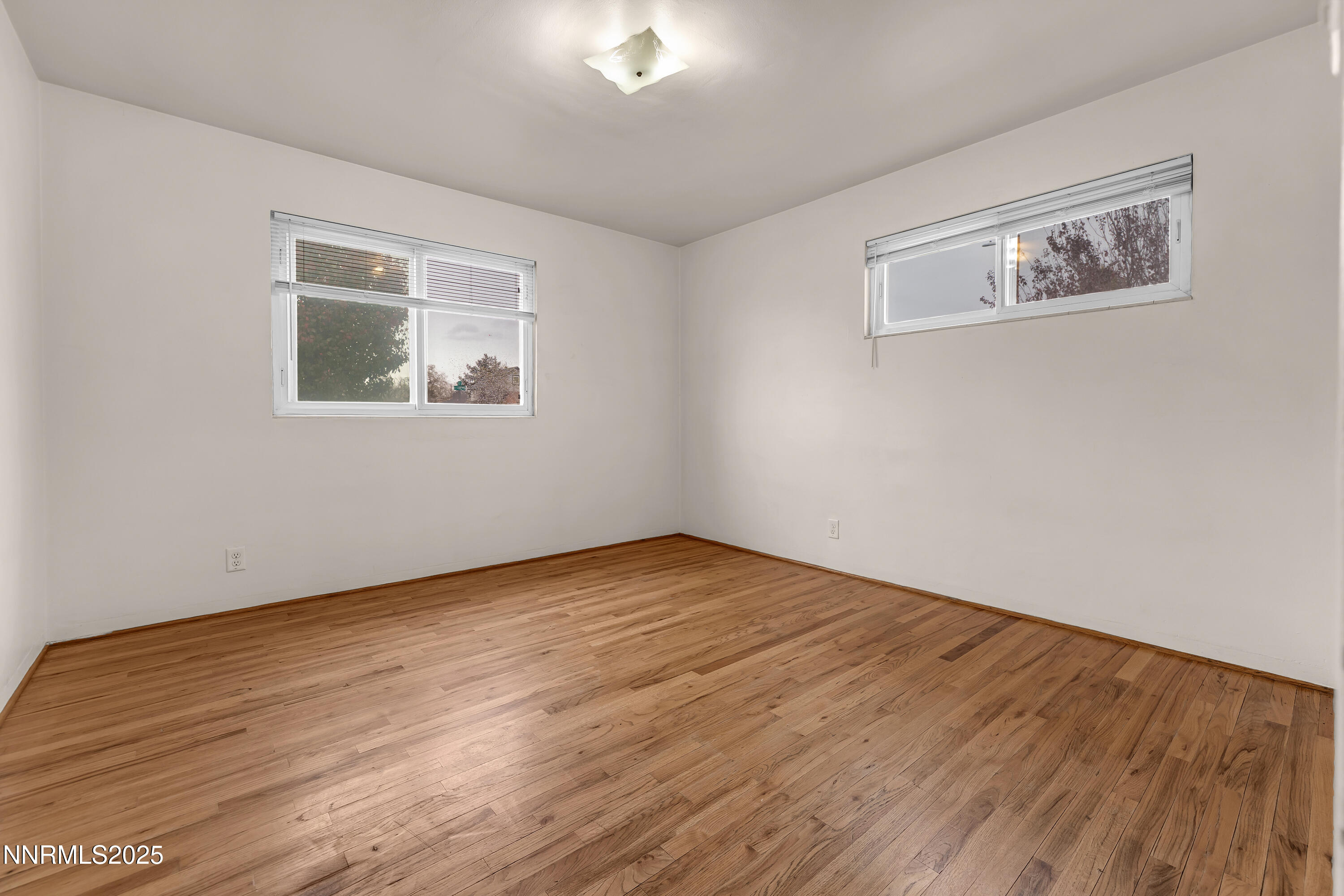 234 18th Street Sparks, NV 89431 - Photo 45 of 51 a view of an empty room with wooden floor and a window