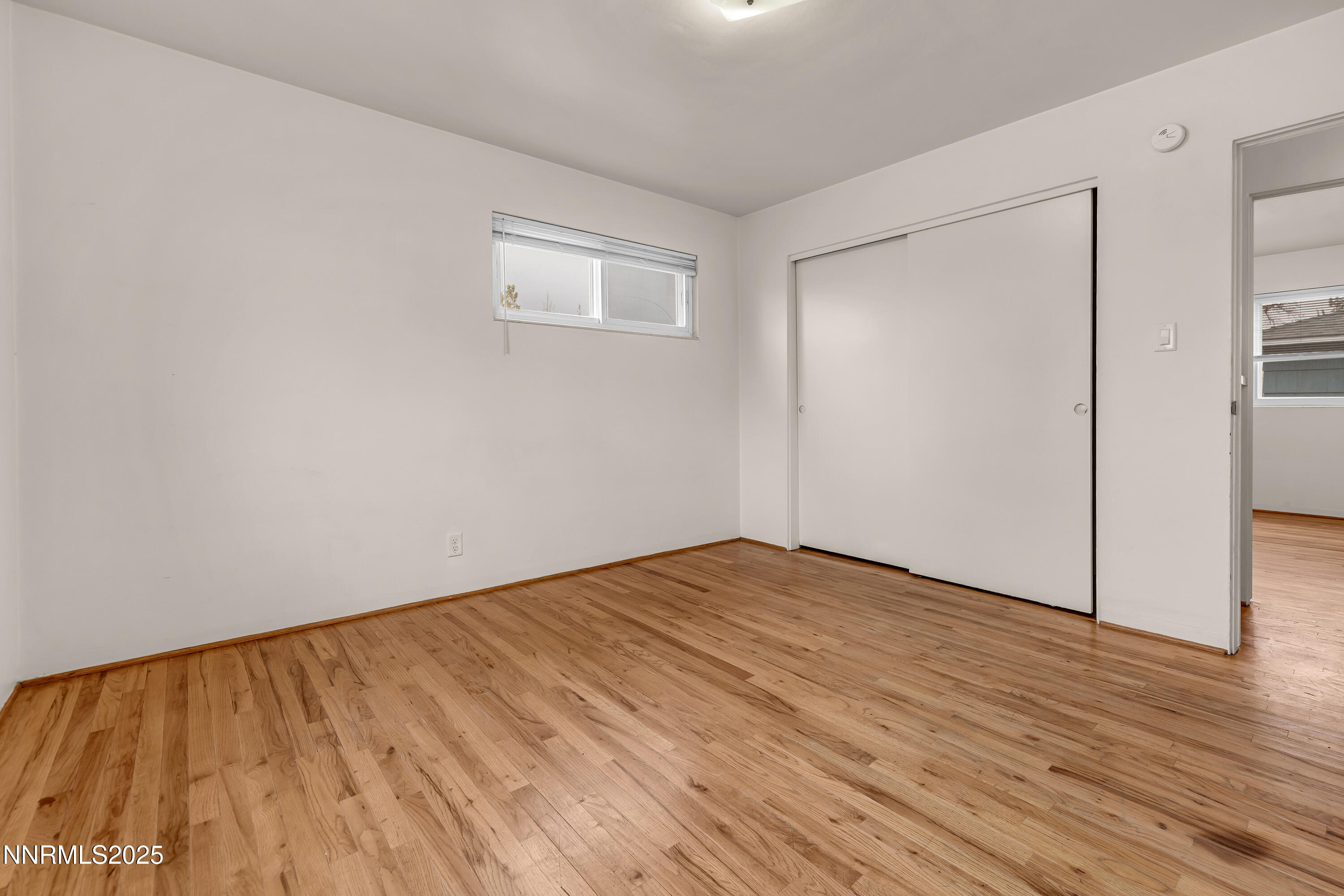 234 18th Street Sparks, NV 89431 - Photo 46 of 51 a view of an empty room with wooden floor and a window
