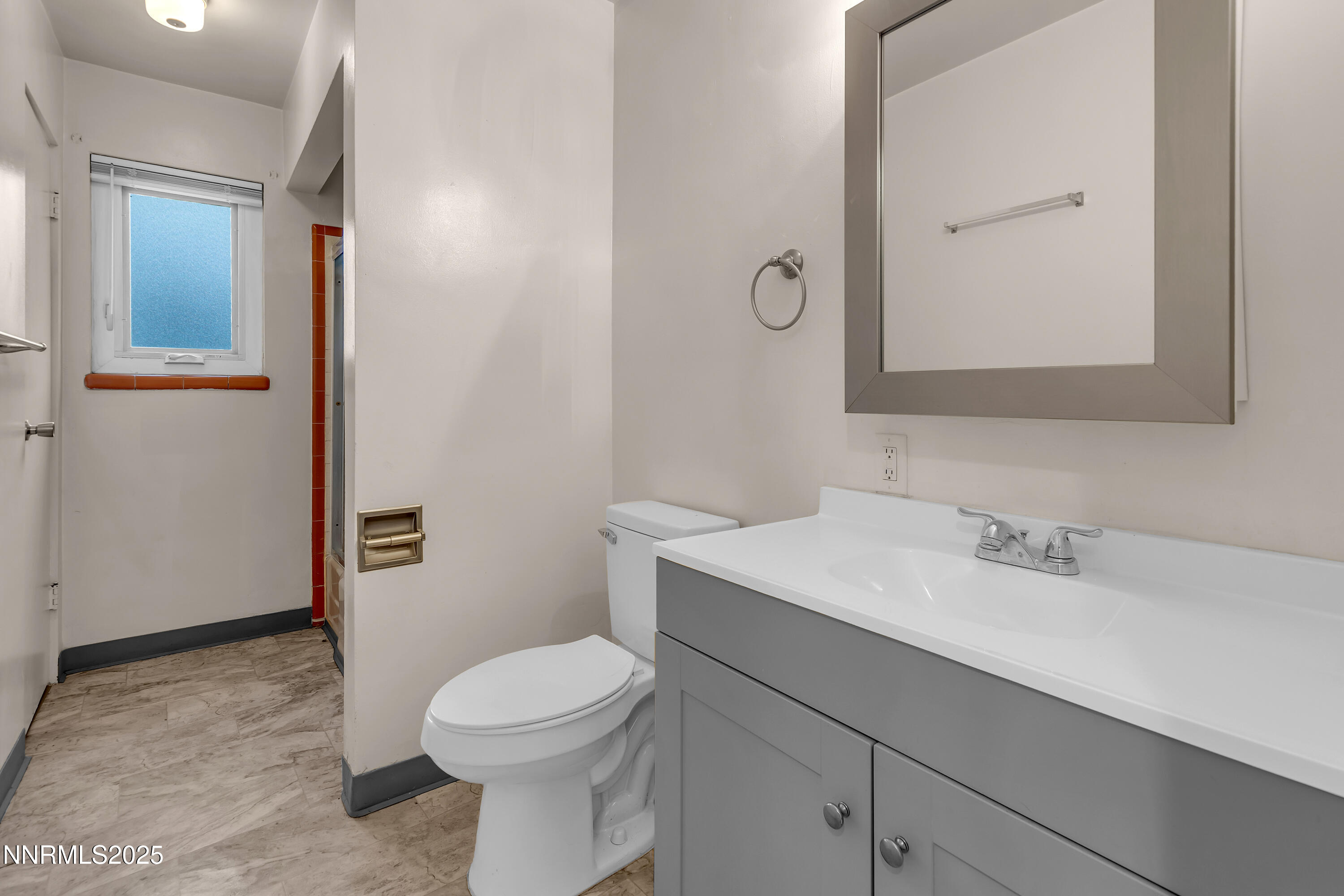 234 18th Street Sparks, NV 89431 - Photo 47 of 51 a bathroom with a sink a toilet and mirror