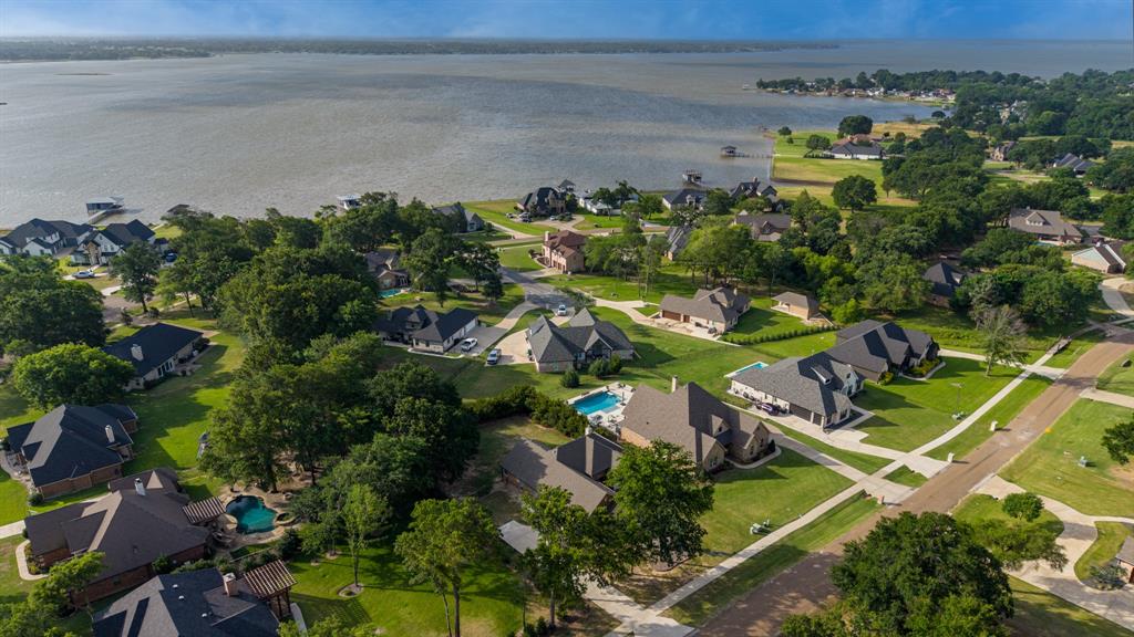101 Lighthouse Lane Mabank, TX 75143 - Photo 32 of 40 Expansive residential area featuring a large body of water, mature trees, manicured lawns, and multiple properties with private swimming pools