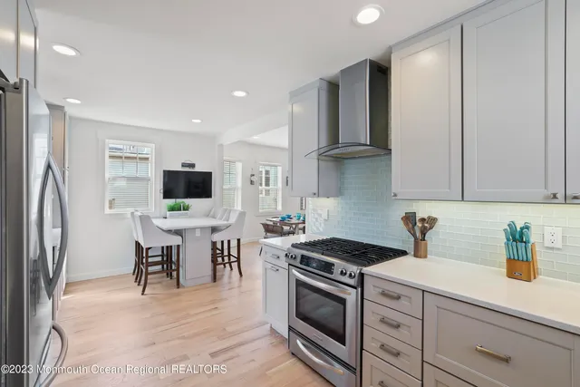 a kitchen with stainless steel appliances a stove a sink refrigerator and cabinets
