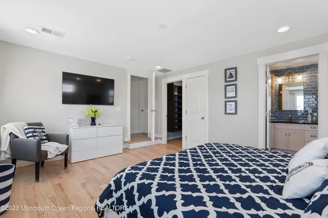 a bedroom with furniture and a flat screen tv