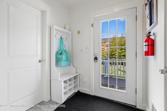 a utility room with dryer and entryway