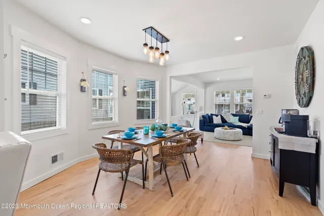 a living room with furniture a dining table and a window