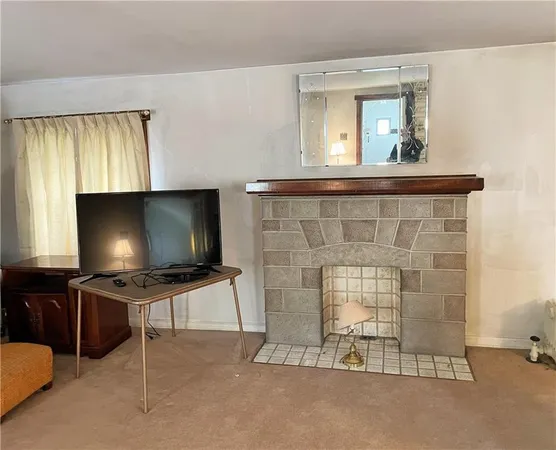 a living room with fireplace furniture and a flat screen tv